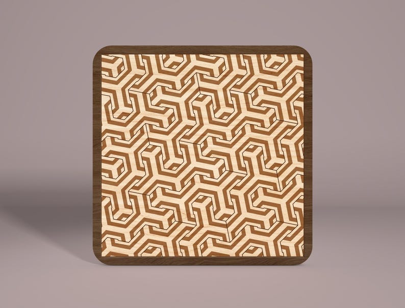 May include: A wooden coaster with a geometric pattern of brown and white lines. The coaster is square and has a dark brown border.