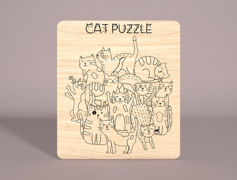 May include: A wooden puzzle featuring a black and white line drawing of a group of cats. The puzzle is titled "CAT PUZZLE".