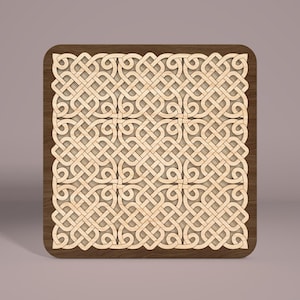 May include: A square wooden coaster with a Celtic knot design. The coaster is made of light brown wood with a dark brown border.