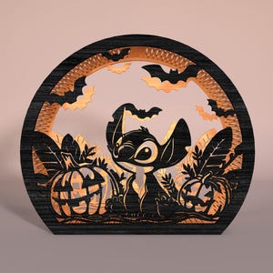 May include: A black wooden Halloween decoration featuring a cartoon character, pumpkins, and bats. The design is laser-cut with intricate details, creating a layered effect. The pumpkins have carved faces, and bats are silhouetted against a light background.