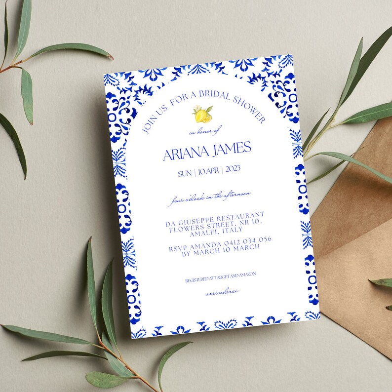May include: A white bridal shower invitation with a blue and white patterned border. The invitation features a lemon illustration and the text "JOIN US FOR A BRIDAL SHOWER in honor of ARIANA JAMES SUN | 10 APR | 2023 four o'clock in the afternoon DA GIUSEPPE RESTAURANT FLOWERS STREET, NR 10, AMALFI, ITALY RSVP AMANDA 0412 034 056 BY MARCH 10 MARCH REGISTERED AT EMZIGE AND AMVON arrivederci"