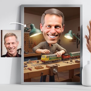 May include: A framed caricature of a man smiling, holding a model train. The train is yellow, red, and green, with the text "EQ 111" on the front. The background shows a workshop with tools and a workbench.