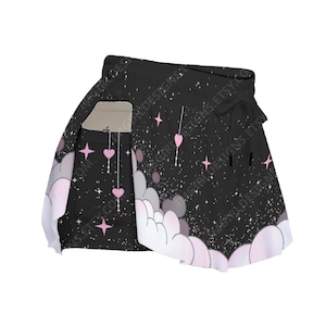May include: Black shorts with a celestial design featuring pink hearts, stars, and clouds. The shorts have a drawstring waistband and a pocket. The design includes the text "GIRLDESIGNS.ETSY.CO".