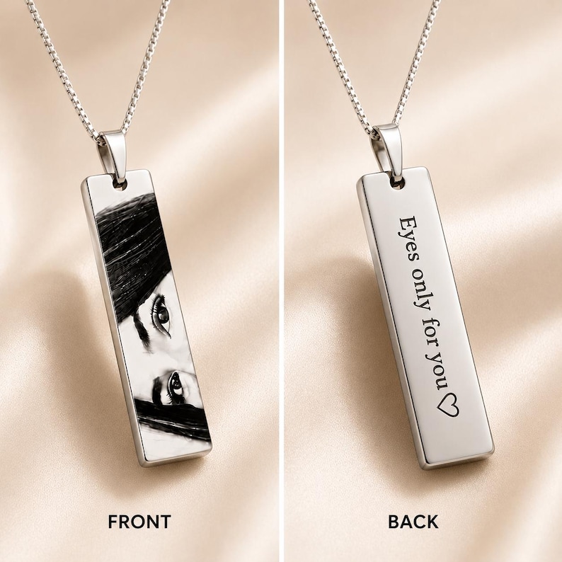 Front and back view of a personalized engraved photo necklace featuring a custom eye portrait on the front and the engraved message "Eyes only for you" with a heart on the back.