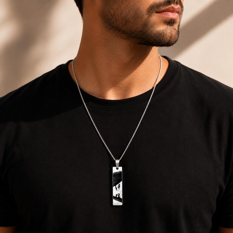 Personalized engraved photo bar necklace on a 24-inch silver Cuban chain worn by a man, custom memorial pendant gift for boyfriend, husband, or dad.