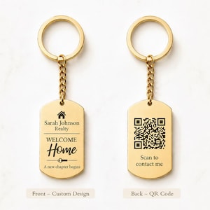 May include: Gold-colored metal keychains with a rectangular tag. One keychain features the text "Sarah Johnson Realty, WELCOME Home, A new chapter begins." The other keychain has a QR code and the text "Scan to contact me."