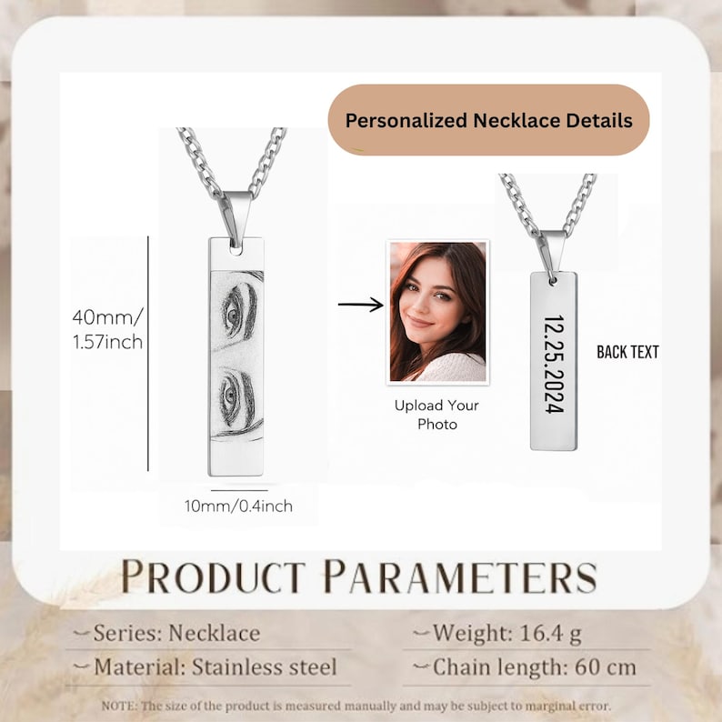 May include: A silver-toned rectangular pendant necklace featuring an engraved portrait of eyes on the front and the date 12.25.2024 on the back. The pendant measures 40mm by 10mm (1.57 inches by 0.4 inches) and hangs from a chain 60 cm in length.