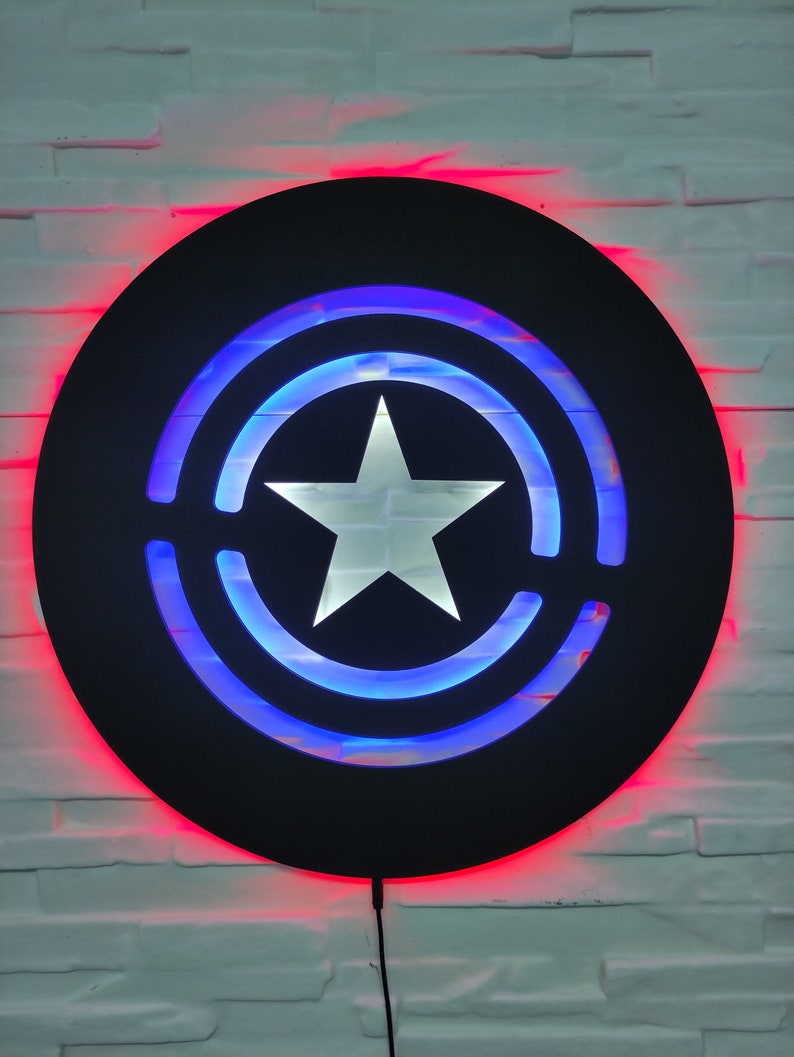 May include: A black circular wall decor with a white star in the center and blue and red LED lights around the edges.