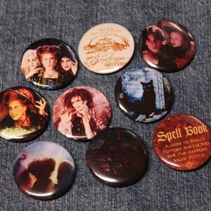 May include: A set of ten 1-inch button pins featuring characters and imagery from the movie Hocus Pocus. The pins feature the Sanderson sisters, a black cat, a spell book, and the Sanderson sisters' house.