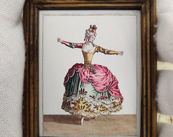 May include: A framed illustration of a woman in a pink, green, and yellow dress with a white lace trim. She is wearing a white wig with a red and green feather decoration. The illustration is on a white background.