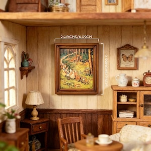 May include: A rectangular miniature wall art piece in a dark wood frame featuring a colorful forest scene with small figures. The frame measures 2.4 inches wide by 2.9 inches high, as indicated by the text overlay on the image.