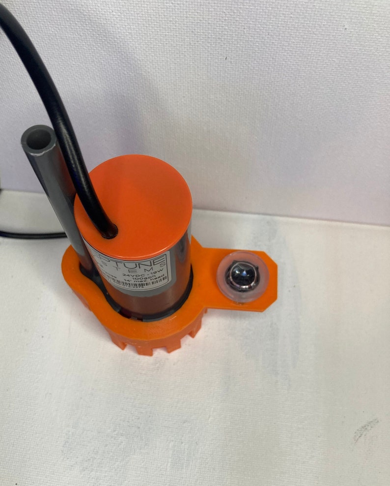 May include: An orange submersible pump with a black cord and a clear plastic cap. The pump has a label that reads "Neptune Systems DC12V 19W 2400 GPH Max Head 1.5m".