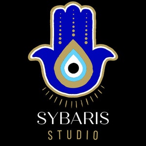 May include: A blue hamsa hand with a gold outline and a blue evil eye in the center. The hamsa hand is surrounded by gold rays. The text "SYBARIS STUDIO" is below the hamsa hand.