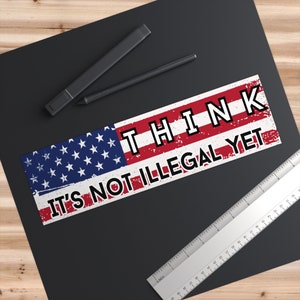 May include: A red, white, and blue American flag sticker with the text "THINK IT'S NOT ILLEGAL YET" in black letters.