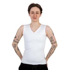 May include: A white sleeveless v-neck shirt with a fitted silhouette. The shirt is made of a soft, stretchy fabric.