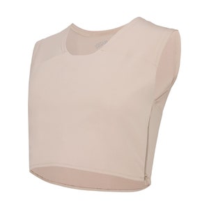 May include: A sleeveless, light beige undershirt with a zipper on the side. The undershirt has a scoop neck and a slightly cropped hem.