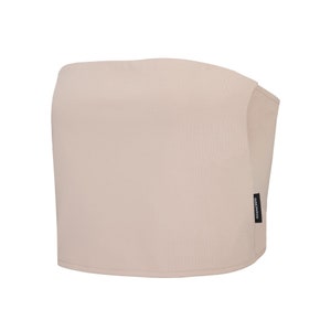 May include: A light beige strapless crop top with a black "ISOLATED" label on the side.