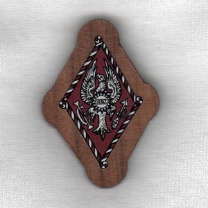 May include: A wooden diamond-shaped plaque with a red and white border. The plaque features a black and white illustration of an eagle with a shield on its chest that says "Deus" and an anchor on each side. The eagle is surrounded by a rope-like design.