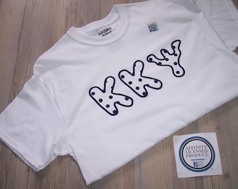 May include: White t-shirt with a black and white graphic of the word "KKYY" in a dotted font. The shirt has a tag that says "Affinity Licensed Product".