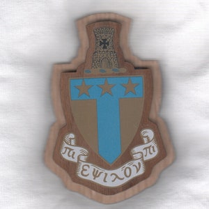 May include: A wooden plaque with a crest featuring a tower, three stars, and a blue T. The crest is surrounded by a scroll with the text "Π ΕΨΙΧΟΝ".