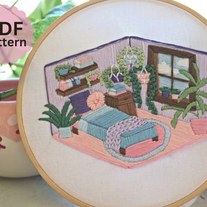May include: Embroidered hoop art depicting a cozy bedroom with a bed, a window with clouds, and plants. The bedroom is decorated in pastel colors, including pink, purple, and green.