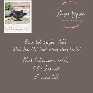 May include: Black bat eyeglass holder made from 1/4 inch birch wood, hand painted. The bat is approximately 8.5 inches wide and 5 inches tall. "Artisan Magic Boutique" is written in a circle with a pink background.