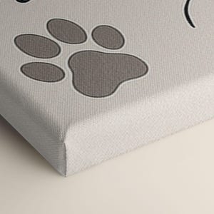Macro shot of the canvas corner featuring the paw print detail, showing texture, quality, and precision of print on the wrapped edge.