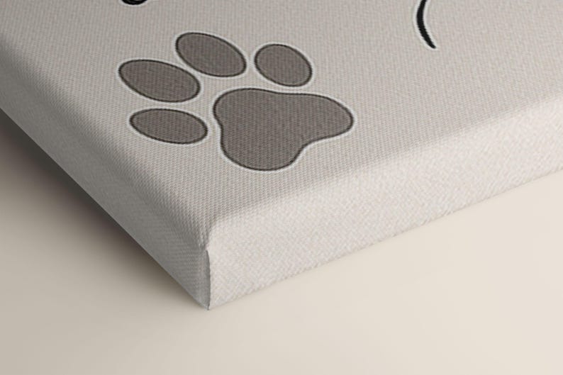 Macro shot of the canvas corner featuring the paw print detail, showing texture, quality, and precision of print on the wrapped edge.