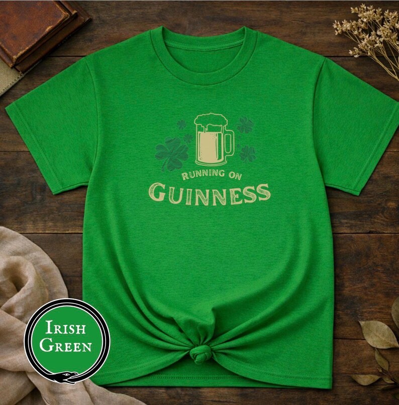 Funny Running on Guinness St Patrick’s Day shirt featuring a beer mug and shamrock design printed on Gildan 5000 unisex t shirts available in black white Irish green and antique Irish green colors, humorous Irish drinking shirt perfect for St Paddy’s Day pub crawls parties festivals and Irish holiday celebrations.