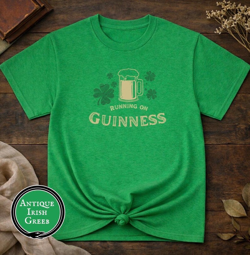 Funny Running on Guinness St Patrick’s Day shirt featuring a beer mug and shamrock design printed on Gildan 5000 unisex t shirts available in black white Irish green and antique Irish green colors, humorous Irish drinking shirt perfect for St Paddy’s Day pub crawls parties festivals and Irish holiday celebrations.