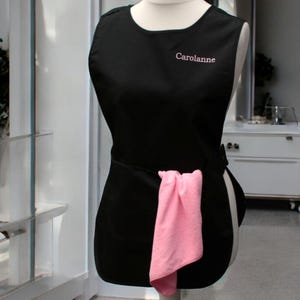 Personalised Ladies name embroidered on a black tabard for workwear cleaning business.
