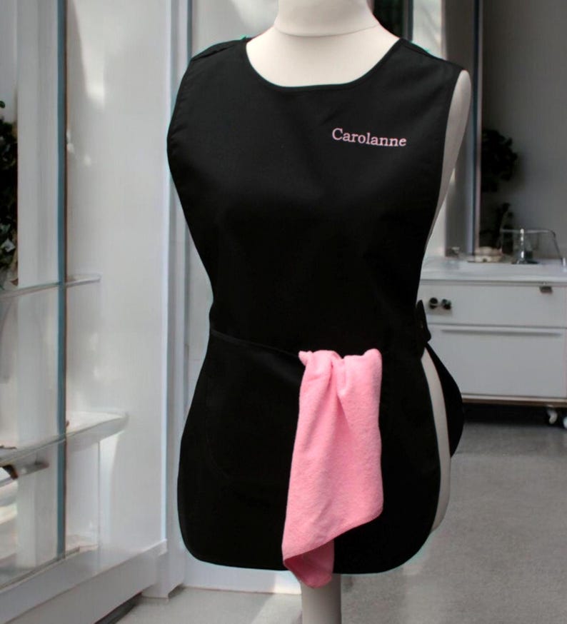 Personalised Ladies name embroidered on a black tabard for workwear cleaning business.