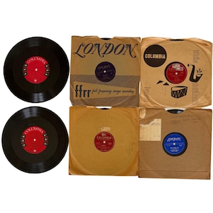 May include: Collection of vintage vinyl records. The records are black with red and white labels. Some are in brown paper sleeves with the "London" and "Columbia" logos. One sleeve has "ffrr full frequency range recording" printed on it.