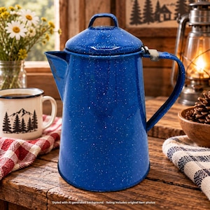 May include: A tall, cylindrical blue enamel coffee percolator with a speckled white finish, a matching lid with a small handle, and a sturdy side handle. The metal pot features a wide base and a tapered spout, showcasing a classic, durable design.