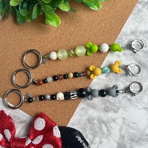 Ear Holder Keychain with Carabiner. Hands-Free Travel Accessory. A Must for Days at the Parks!