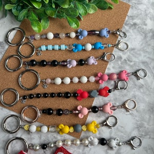 Ear Holder Keychain with Carabiner. Hands-Free Travel Accessory. A Must for Days at the Parks!