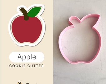 Peut inclure: Emporte-pièce en forme de pomme rose à côté d'un dessin de pomme rouge avec une feuille verte. Le mot "Apple" et "COOKIE CUTTER" sont affichés. Le logo Hivemade Customs est en bas.