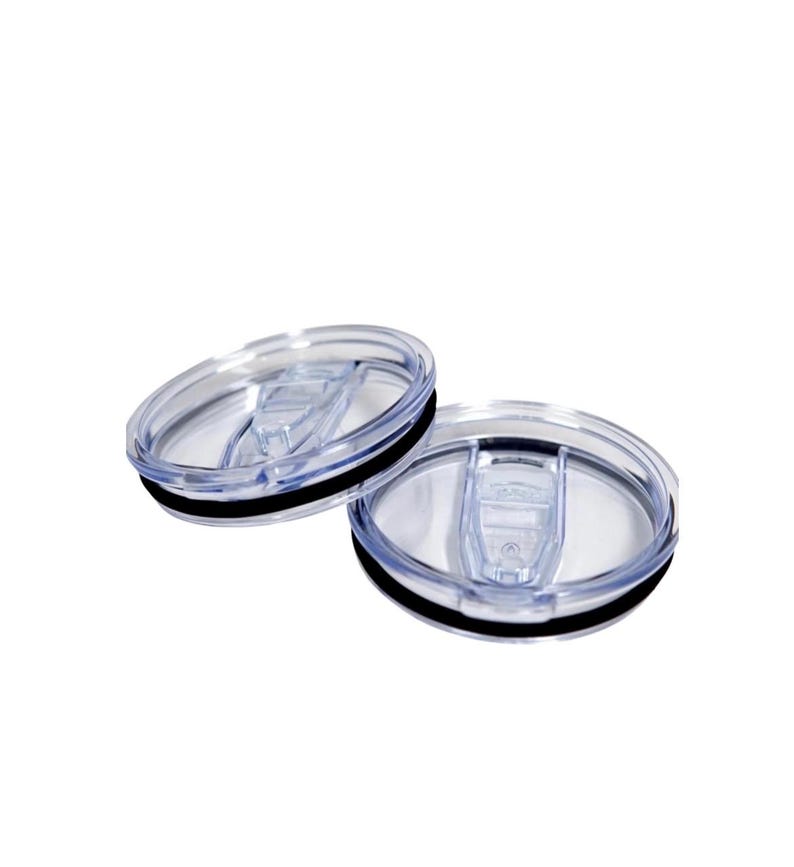 May include: Two clear plastic tumbler lids with a black rubber seal. The lids have a sliding closure mechanism. The lids are designed to fit on a tumbler or travel mug.