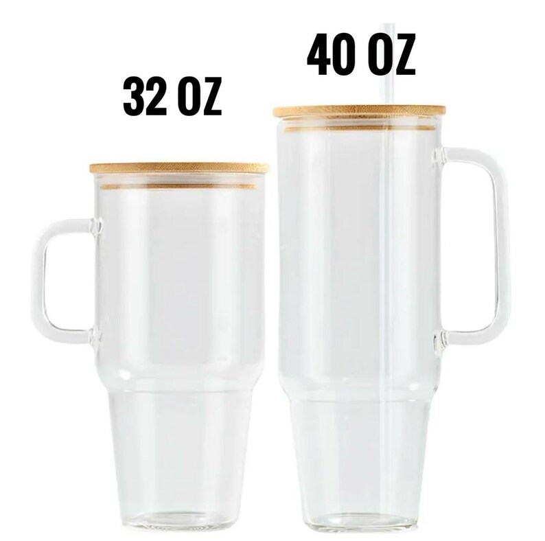 May include: Two clear glass mugs with bamboo lids and handles. The mug on the left is labeled "32 OZ" and the mug on the right is labeled "40 OZ" and has a straw. Both mugs are empty and ready to be filled.