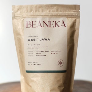 May include: A brown paper bag of BEANEKA coffee from West Java, Indonesia. The label details the single origin, roast, and notes of cinnamon, lemon, red cherry, and citrus. The bag contains 225g of coffee.