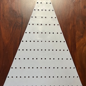 May include: White plastic triangle-shaped bead board with rows of evenly spaced holes. The board has numbers printed along the side.