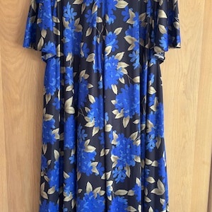 May include: A set of three ceramic canisters with lids, featuring a geometric pattern in shades of blue, white, and gray. The canisters vary in size, suitable for kitchen storage.