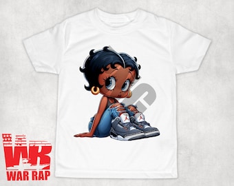 May include: White t-shirt featuring a cartoon image of a Black Betty Boop wearing blue jeans and a pair of grey and red trainers.