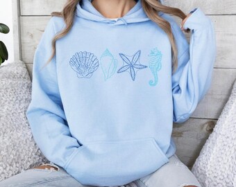 May include: A light blue hooded sweatshirt with an embroidered design of seashells, a starfish, and a seahorse.