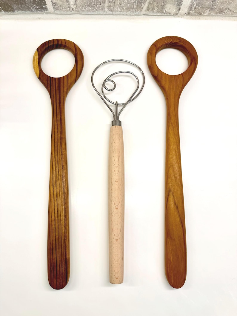 Size comparison of the teakwood dough whisk and the metal dough whisk.