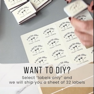 May include: A sheet of cream-colored labels with the text "a tini bit older" and a martini glass design. The text "Want to DIY?" is displayed below the labels, along with instructions.