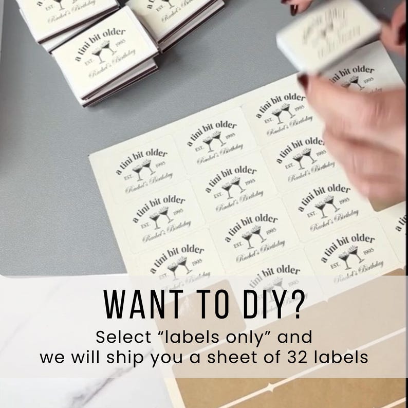 May include: A sheet of cream-colored labels with the text "a tini bit older" and a martini glass design. The text "Want to DIY?" is displayed below the labels, along with instructions.