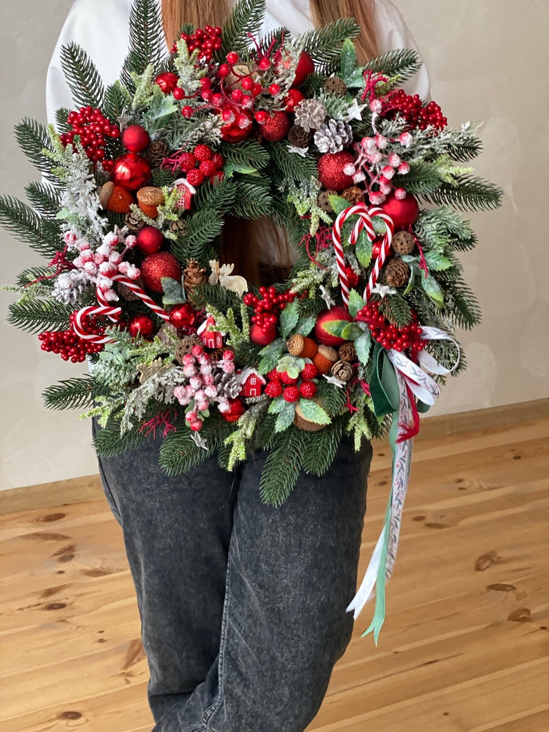 Red christmas wreath for front door with pinecones, red berries and pine. image 1