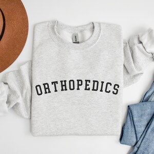 Orthopedics Crewneck Sweatshirt, Orthopedic Doctor Sweater, Ortho Nurse, Orthopedic Gift, Graduation Gift, Orthopedic Surgery