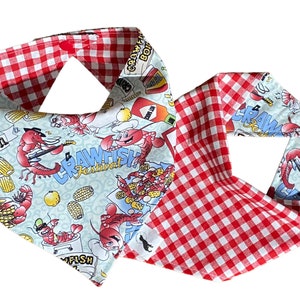 May include: A red and white checkered bandana with a blue and white print featuring crawfish, corn, and lemons. The print includes the text "Crawfish Festival".